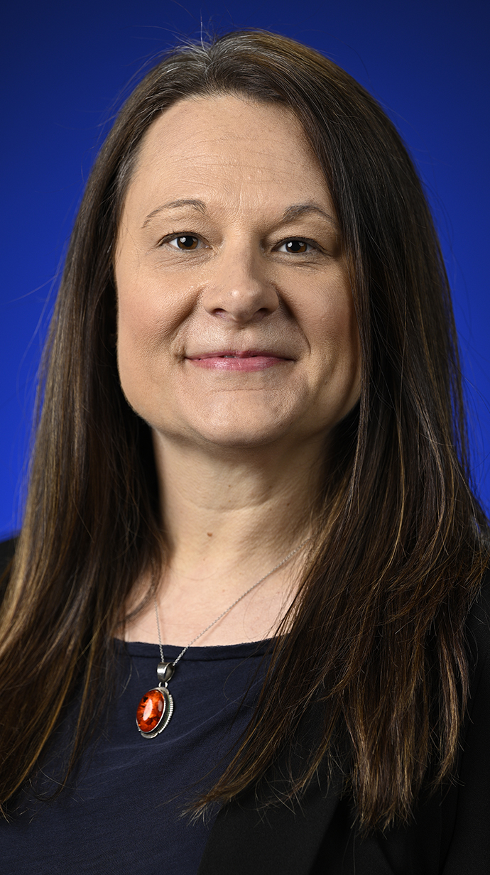 Headshot of a woman wearing a dark blue blouse.
