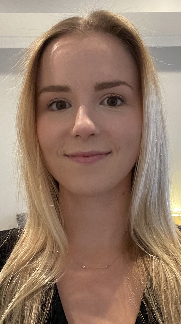 Headshot of a young woman wearing a black top.