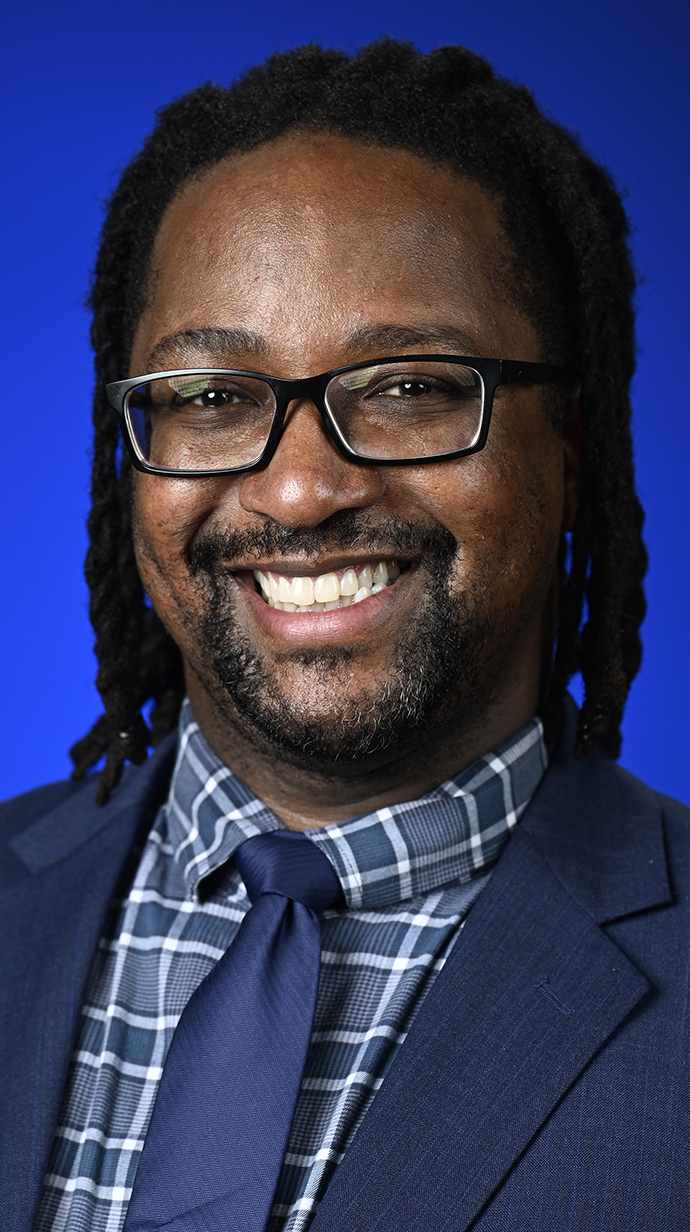 Headshot of a man wearing a dark suit.