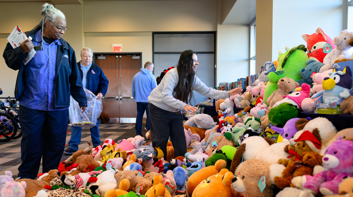 An image of UM employees looking at toys at last year's Books & Bears event.
