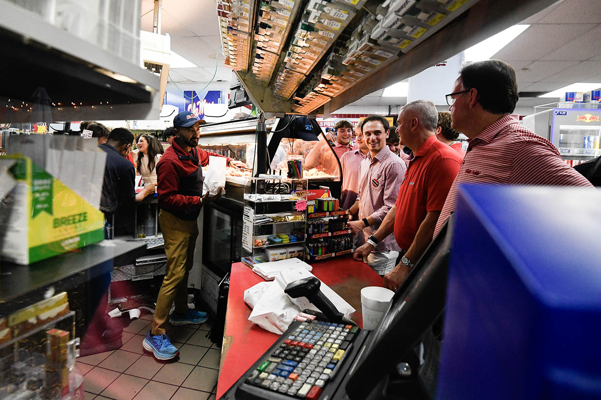 Inside 4 Corners Chevron, a busy crowd fills the small store as owner Rafiq Rupani works behind the counter.