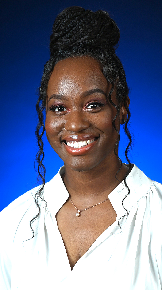 Headshot of a woman wearing a white blouse.