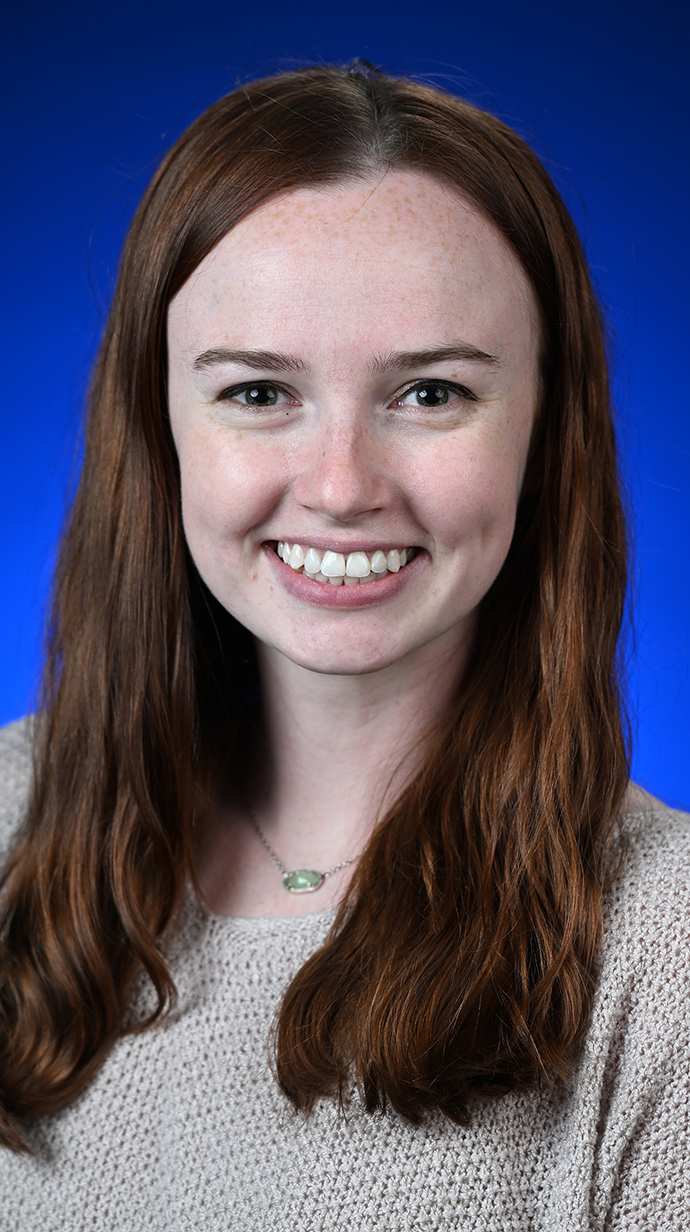 Headshot of a woman wearing a beige sweater.