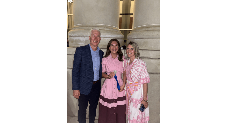 Sadie Keyes showing off her Taylor Medal with her parents by her side after the awards ceremony.