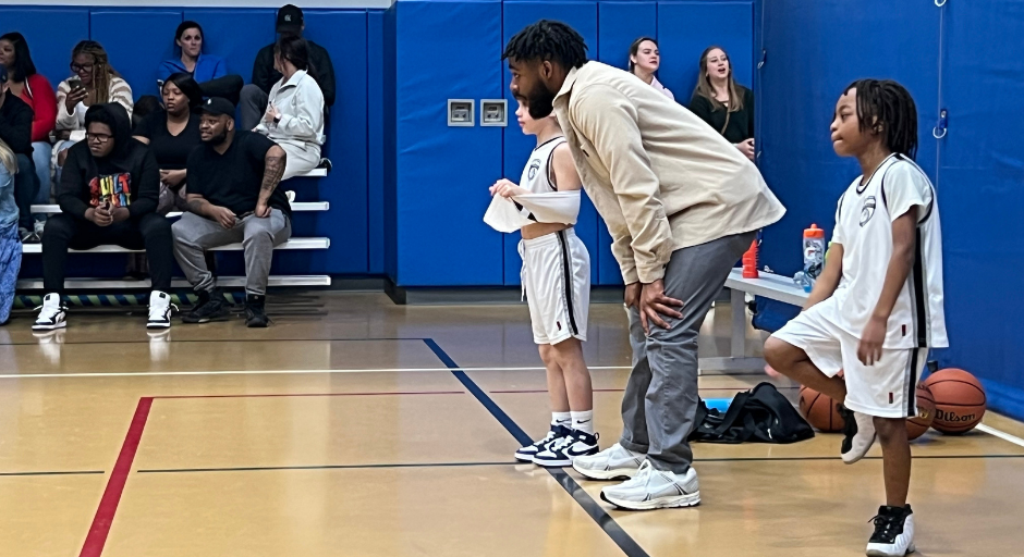 An image of Kaleb Henry coaching basketball.