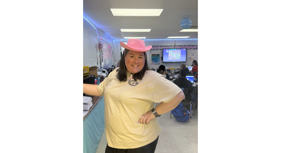 Keisha Harrison wearing a pink cowboy hat in her classroom.