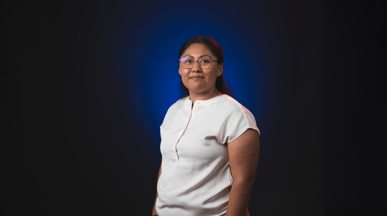 An image of Angela Roberts in front of a blue backdrop.