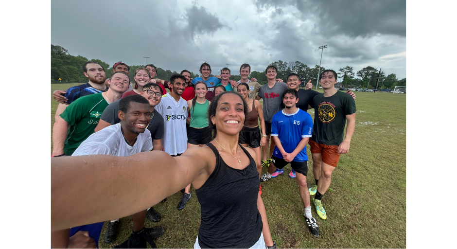 An image of Elizabeth Basha taking a selfie with friends after a rainy soccer game.