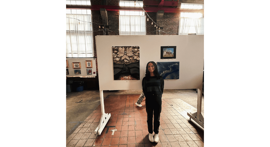 An image of Sarah Basha with her art at the Honors College Art Show. 
