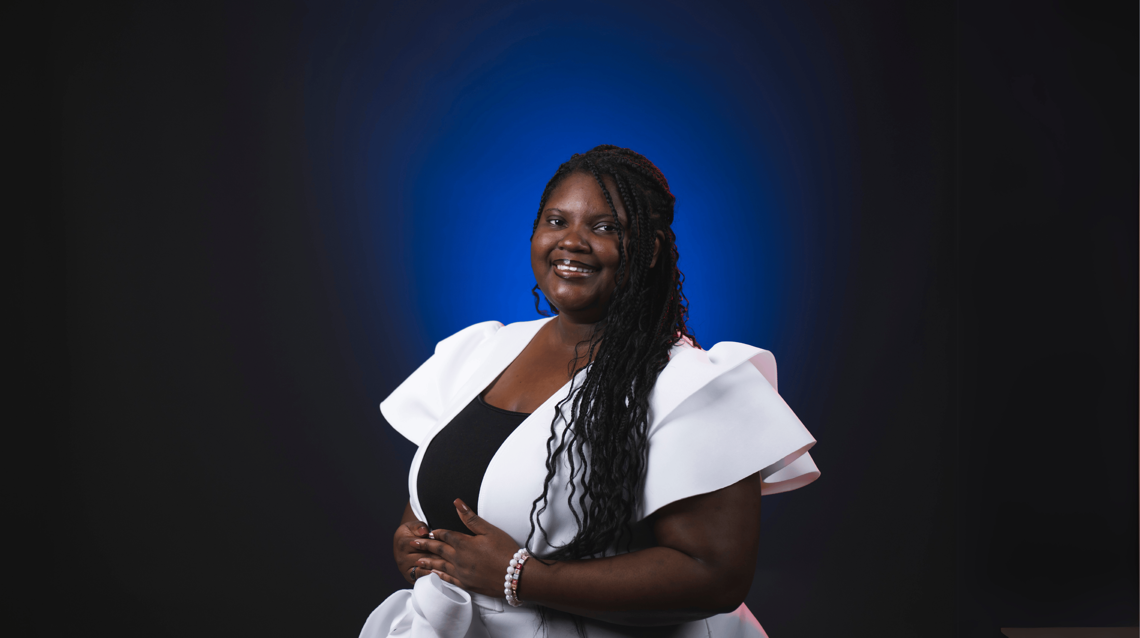 An image of Caitlin Parker in front of a blue backdrop.