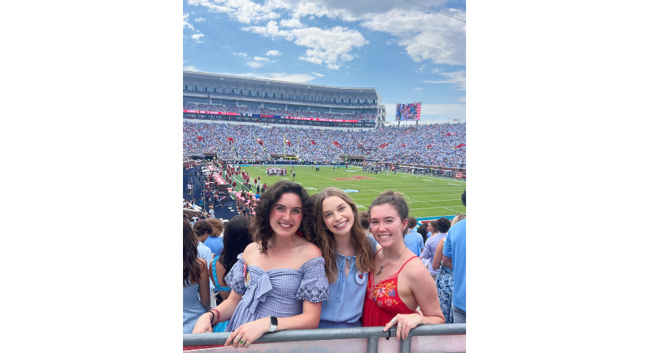 An image of Izzy Arthurs, Claire Reynolds and Caroline McCutchen at a home football game. 