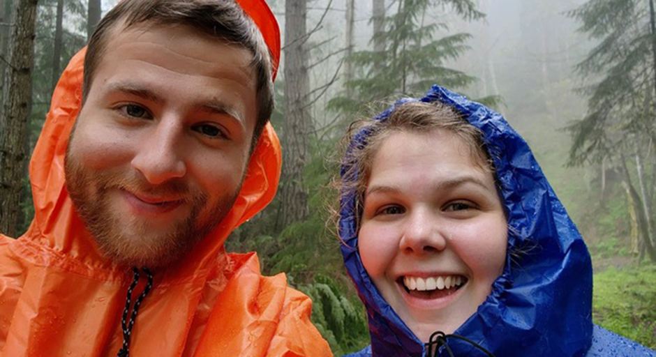 Man and woman in rain jackets taking a selfie