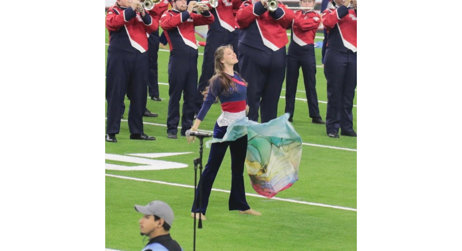 Eva Reynolds performs on the football field with the Pride of the South Marching Band. 
