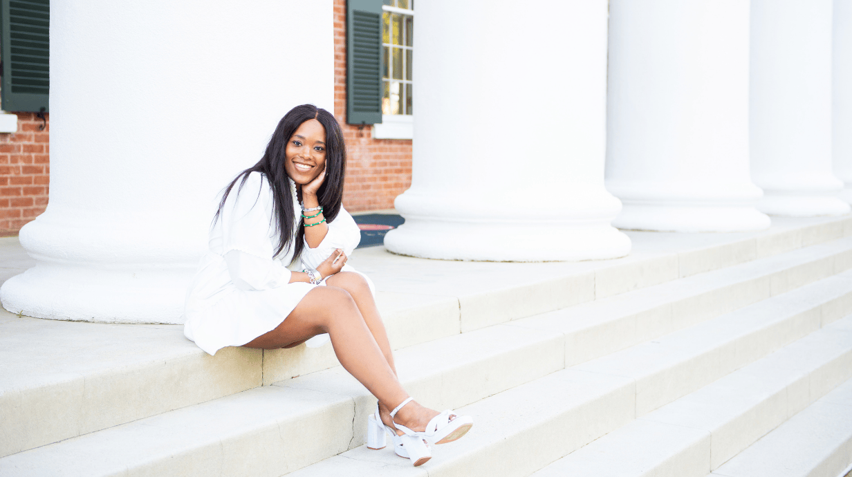 An image of Janelle Minor sitting on the steps of the Lyceum.