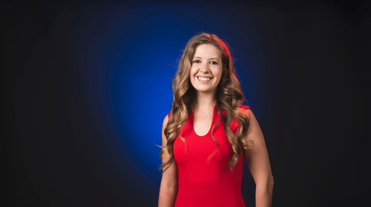An image of Meredith Whited in front of a blue backdrop.