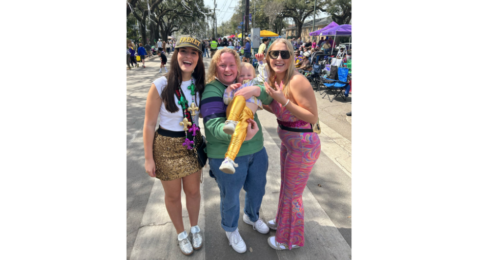 Merritt Tompkins holding her younger cousin, Summer, with Rayne Swanson and sister Summer Tompkins at Mardi Gras.