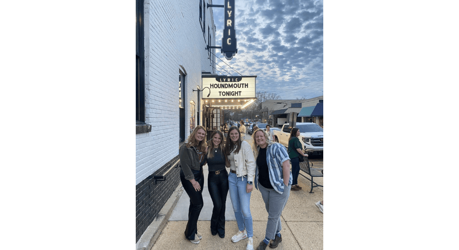 An image of Margaret Donaldson, Sarah Donaldson, Laura Grace Warren, and Merritt Tompkins outside of the Lyric before a Houndmouth concert.