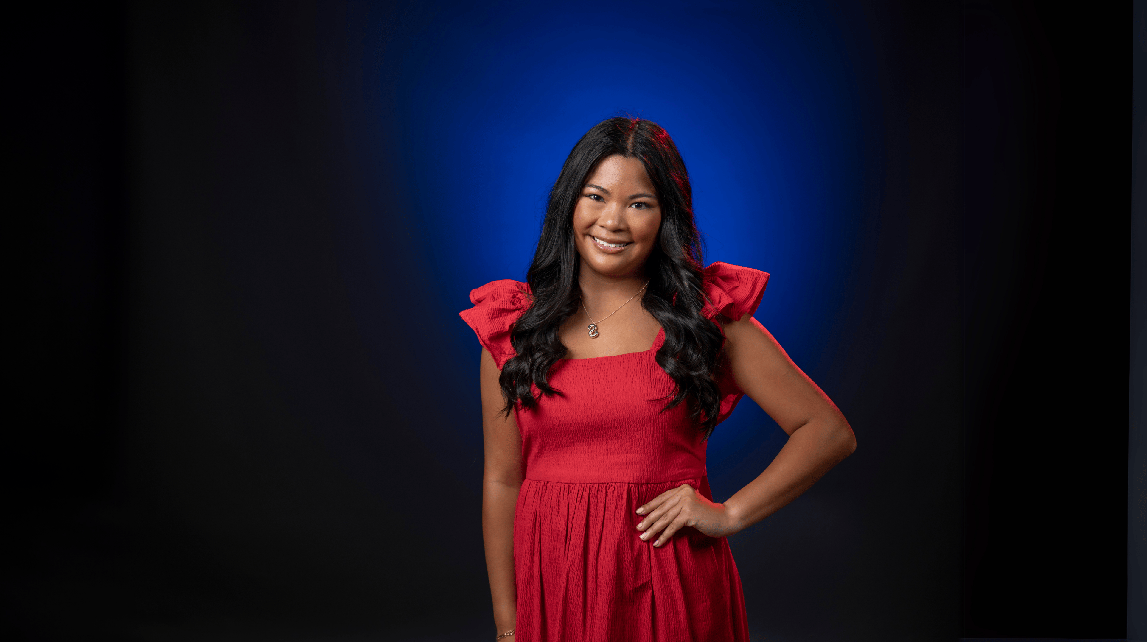 An image of Shaelen Hudson in front of a blue backdrop.