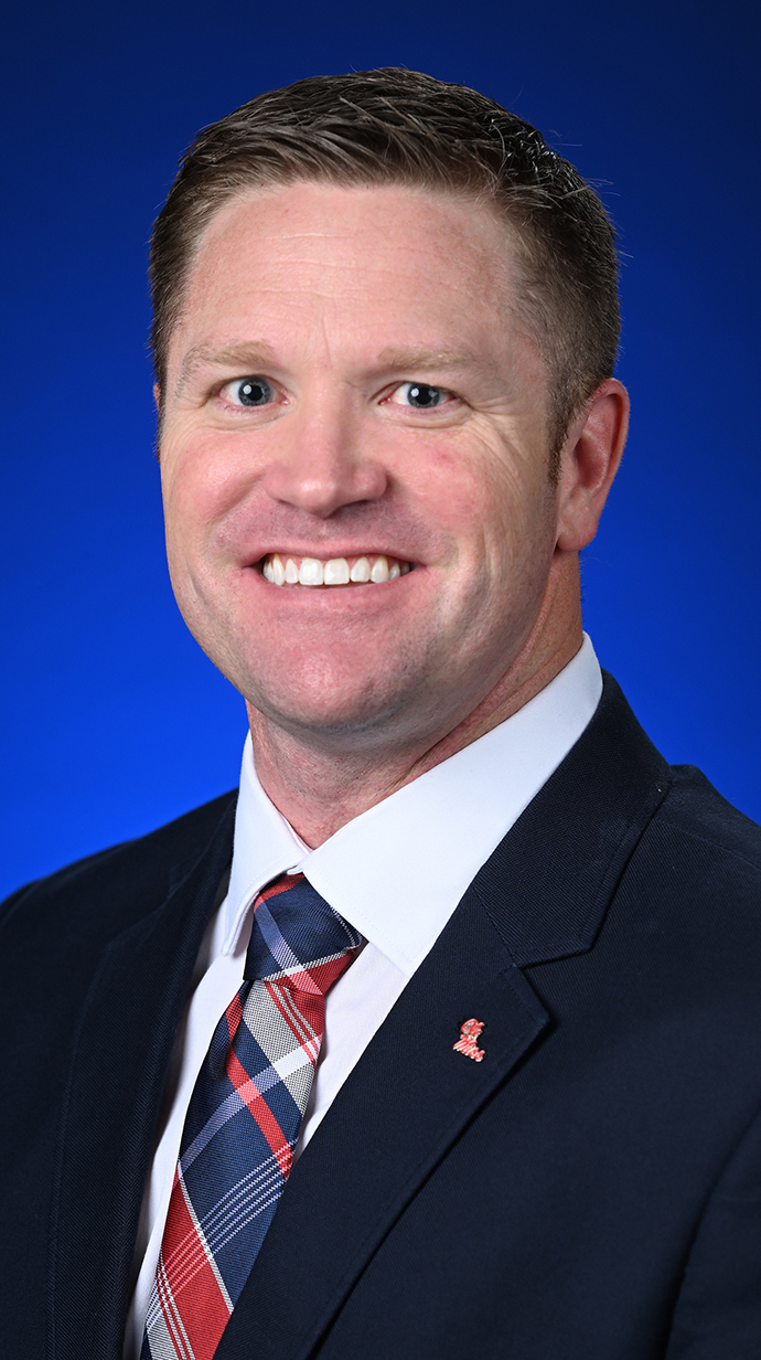 Headshot of a man wearing a dark suit.