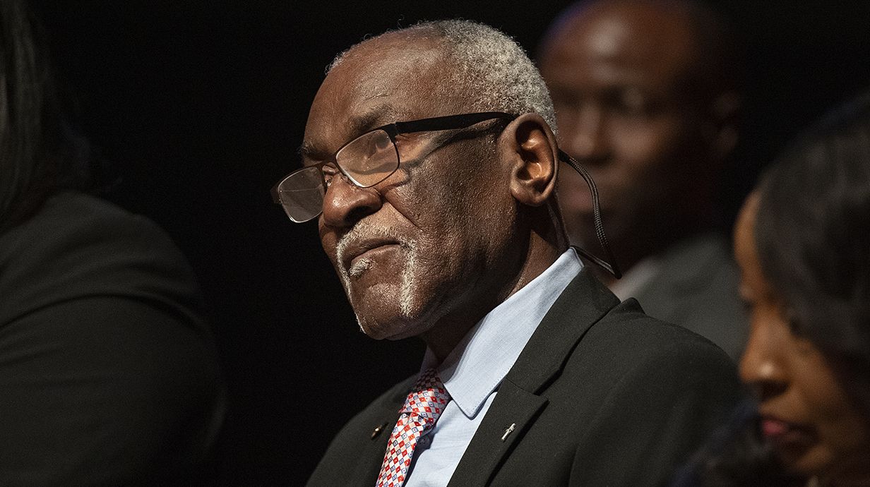Donald Cole sits in an auditorium. 