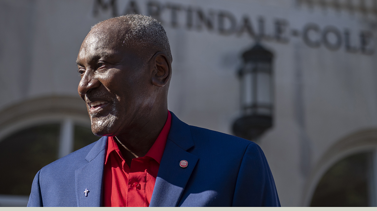 Donald Cole poses for a photo in front of the student services center that bears his name. 