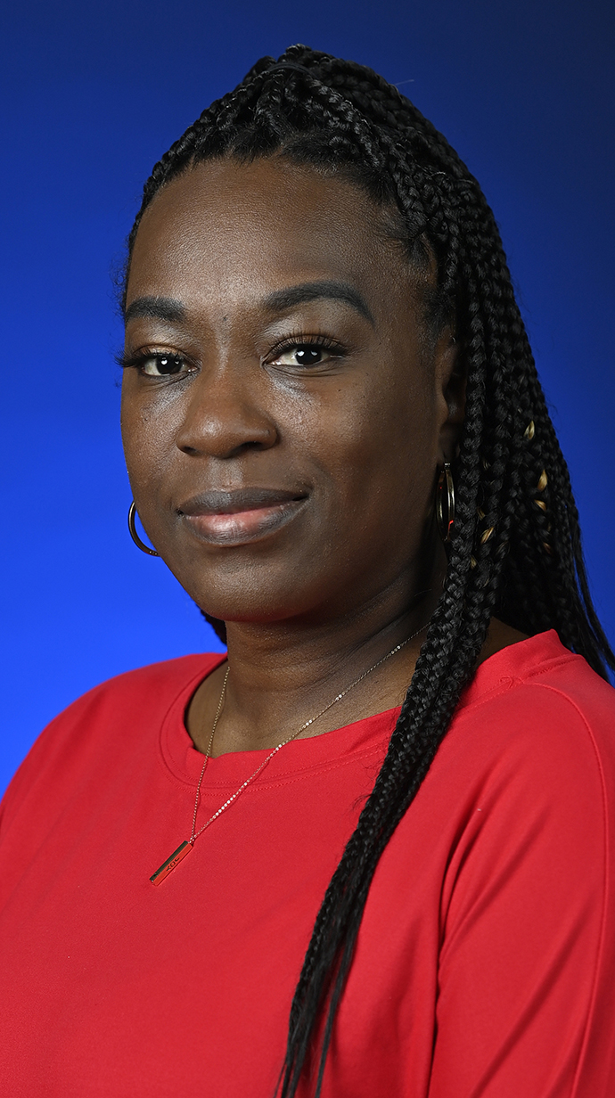 Headshot of a woman wearing a red blouse.