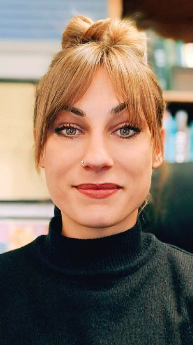 Headshot of a woman wearing a dark sweater with a high neck.
