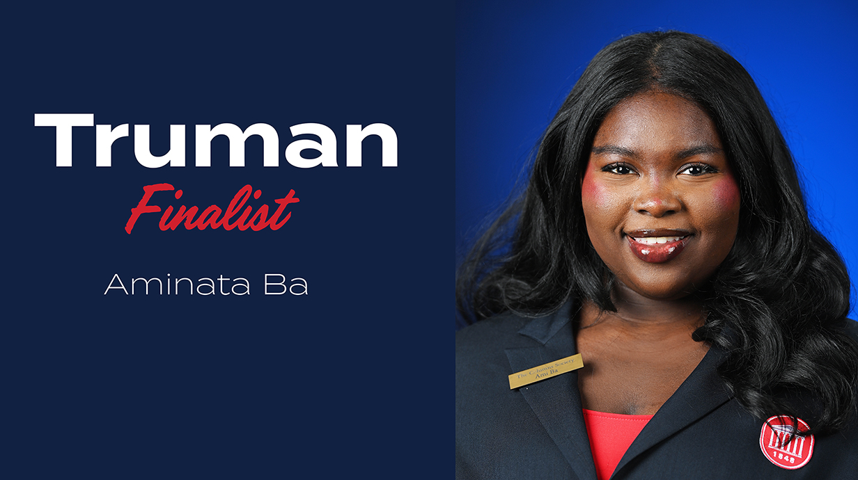 Headshot of a young woman wearing a navy blue blazer over a red blouse with the words 'Truman Finalist Aminata Ba' added to the left of the photo.