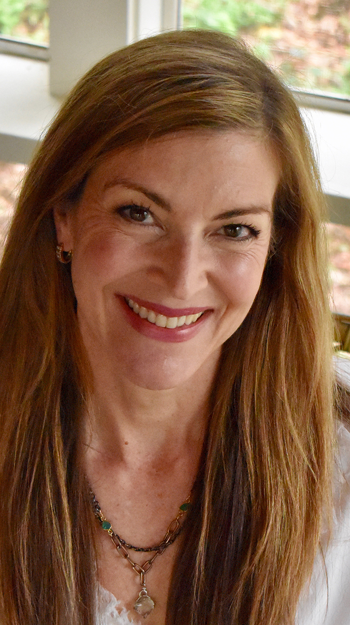 Headshot of a woman wearing a white blouse.