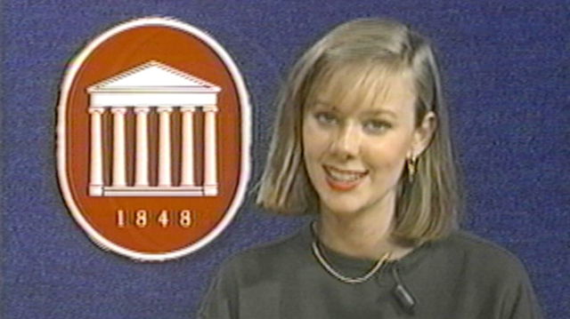 A young woman appears on a TV news broadcast with a red Ole Miss logo on the left.