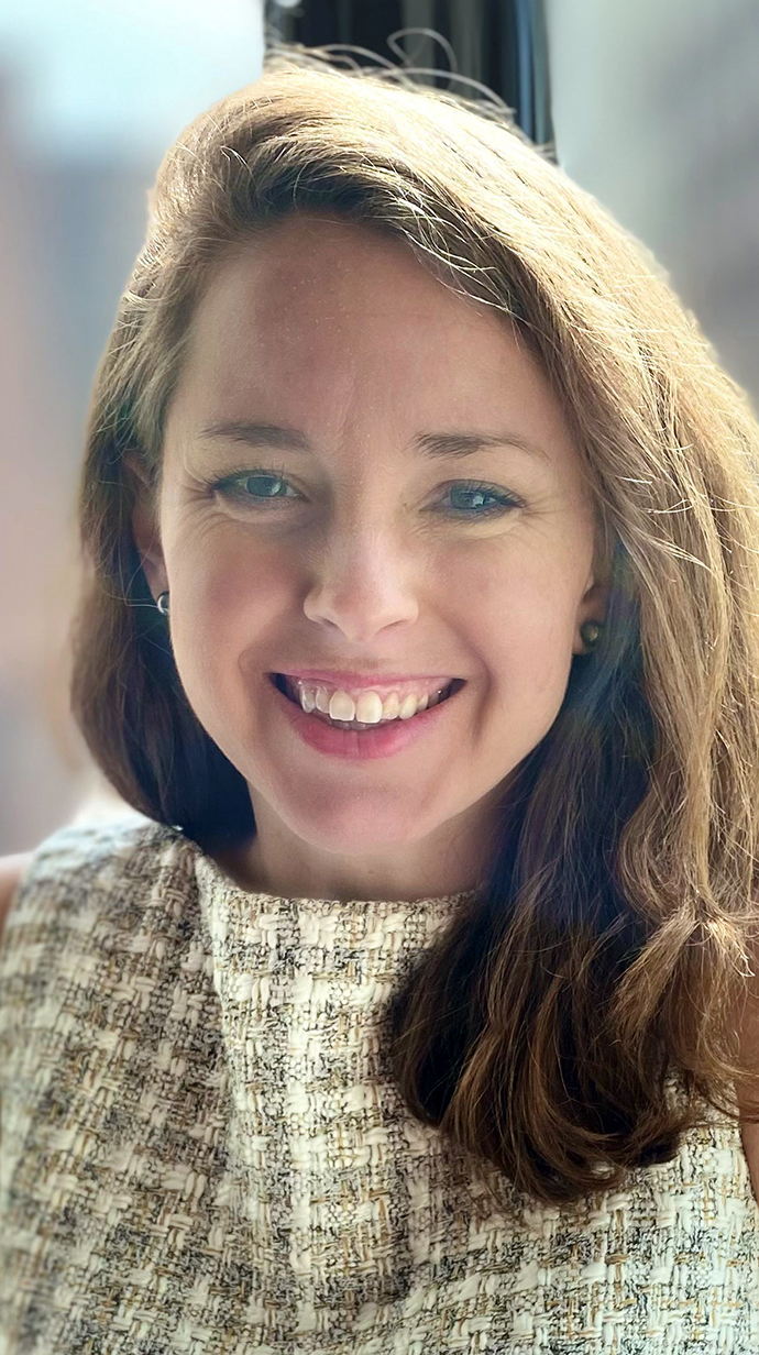 Headshot of a woman wearing a patterned blouse.