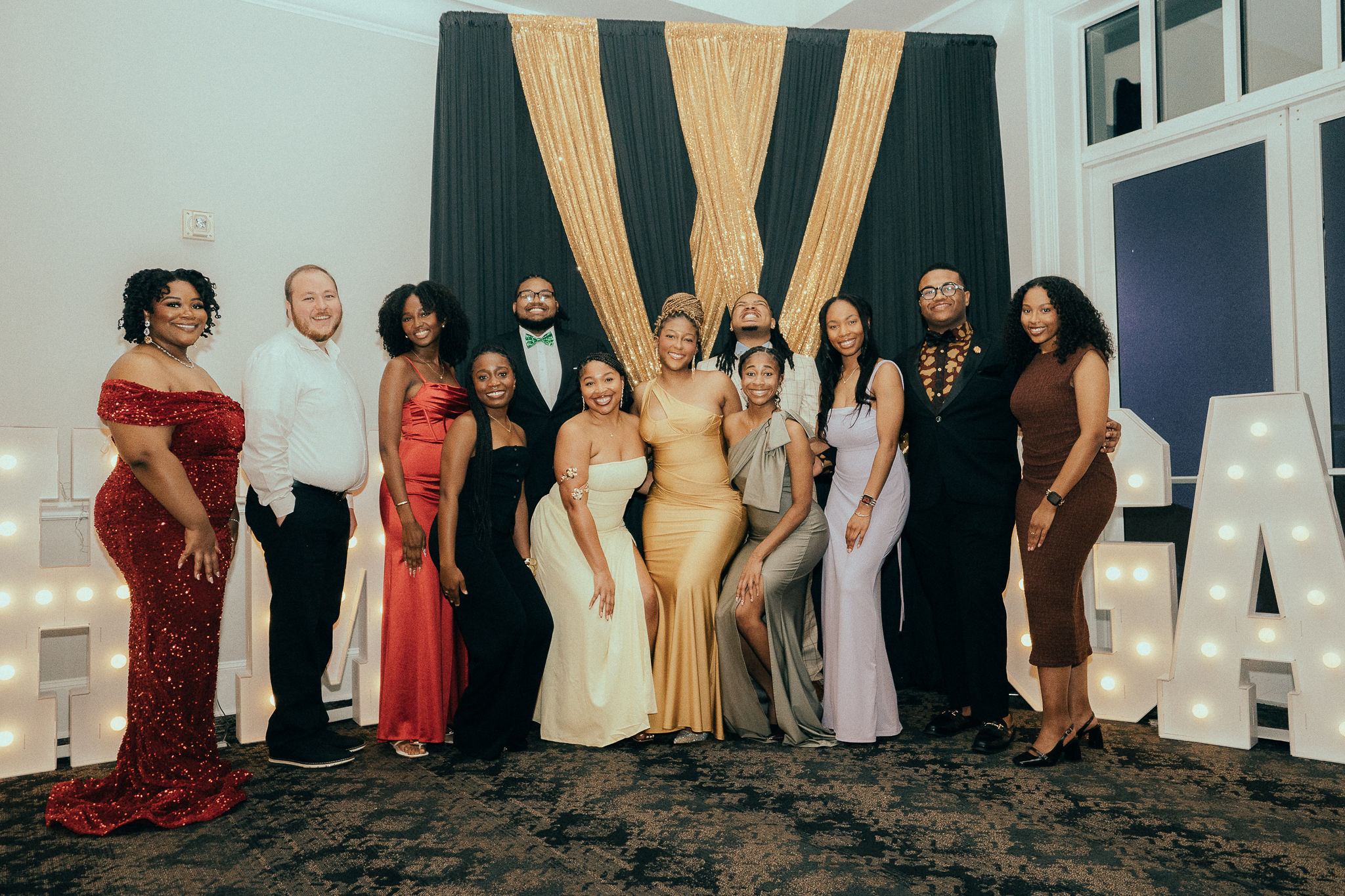 Several young people pose for a picture at a gala. 