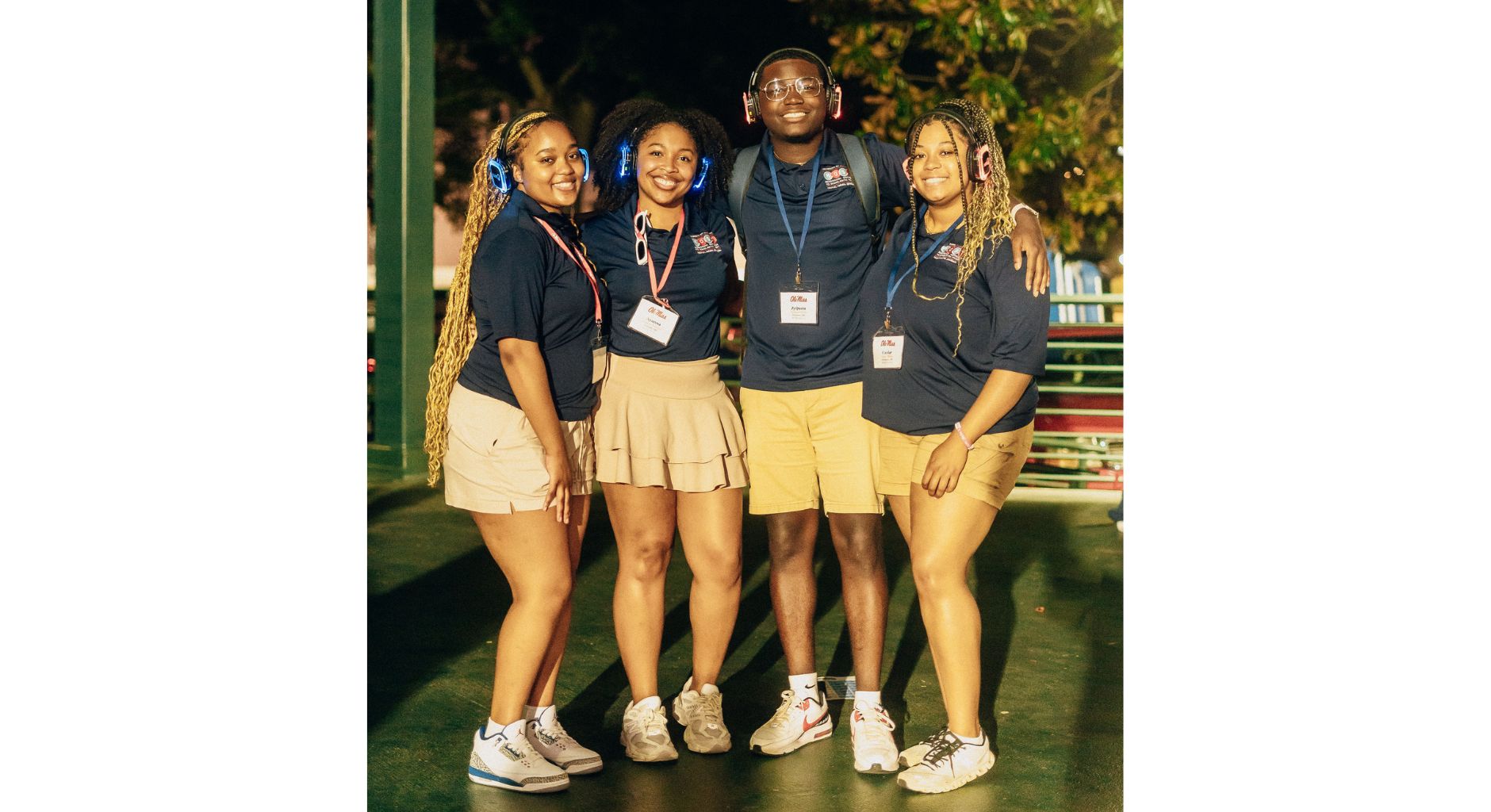 Three young women and a young man  enjoy a silent disco event.