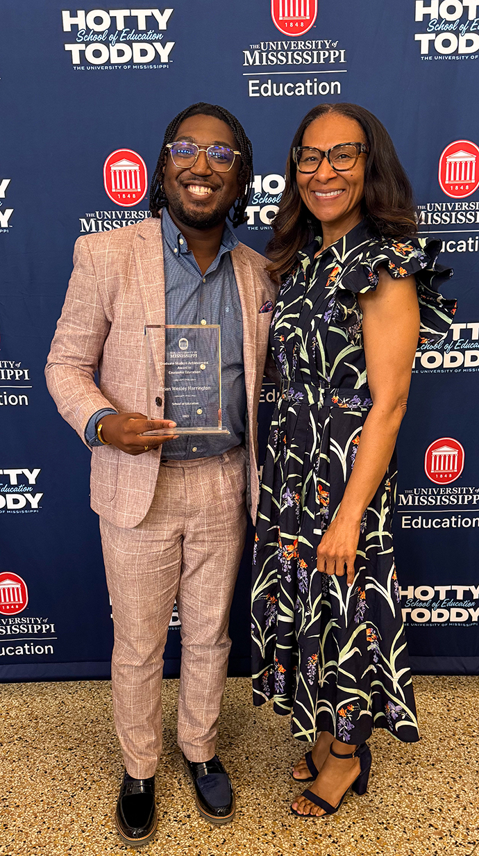 Harrington poses with Stephanie Lusk, professor of leadership and counselor education.