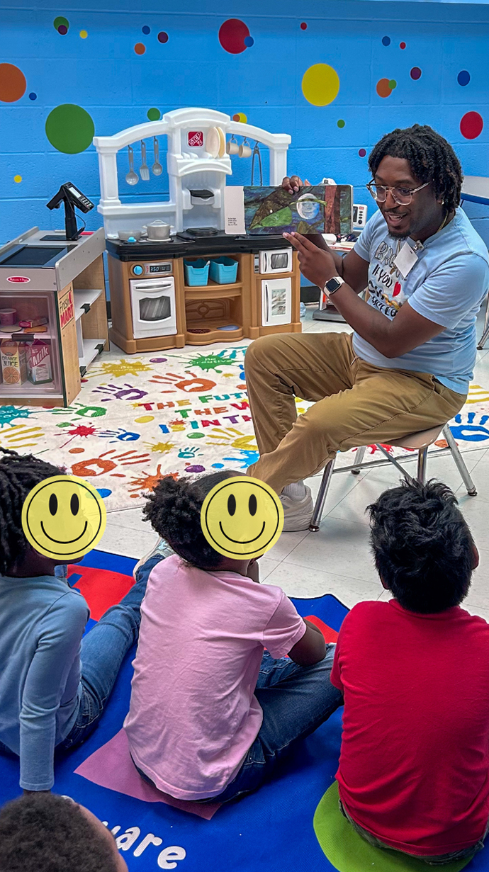 Harrington reads to a class of first graders.