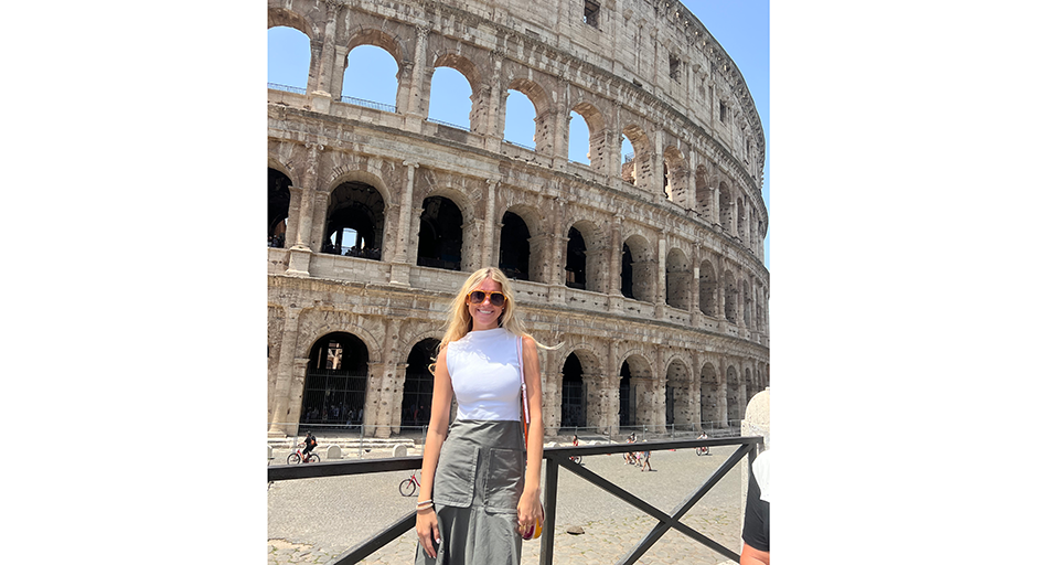 Collins stands in front of the Colosseum in Italy.