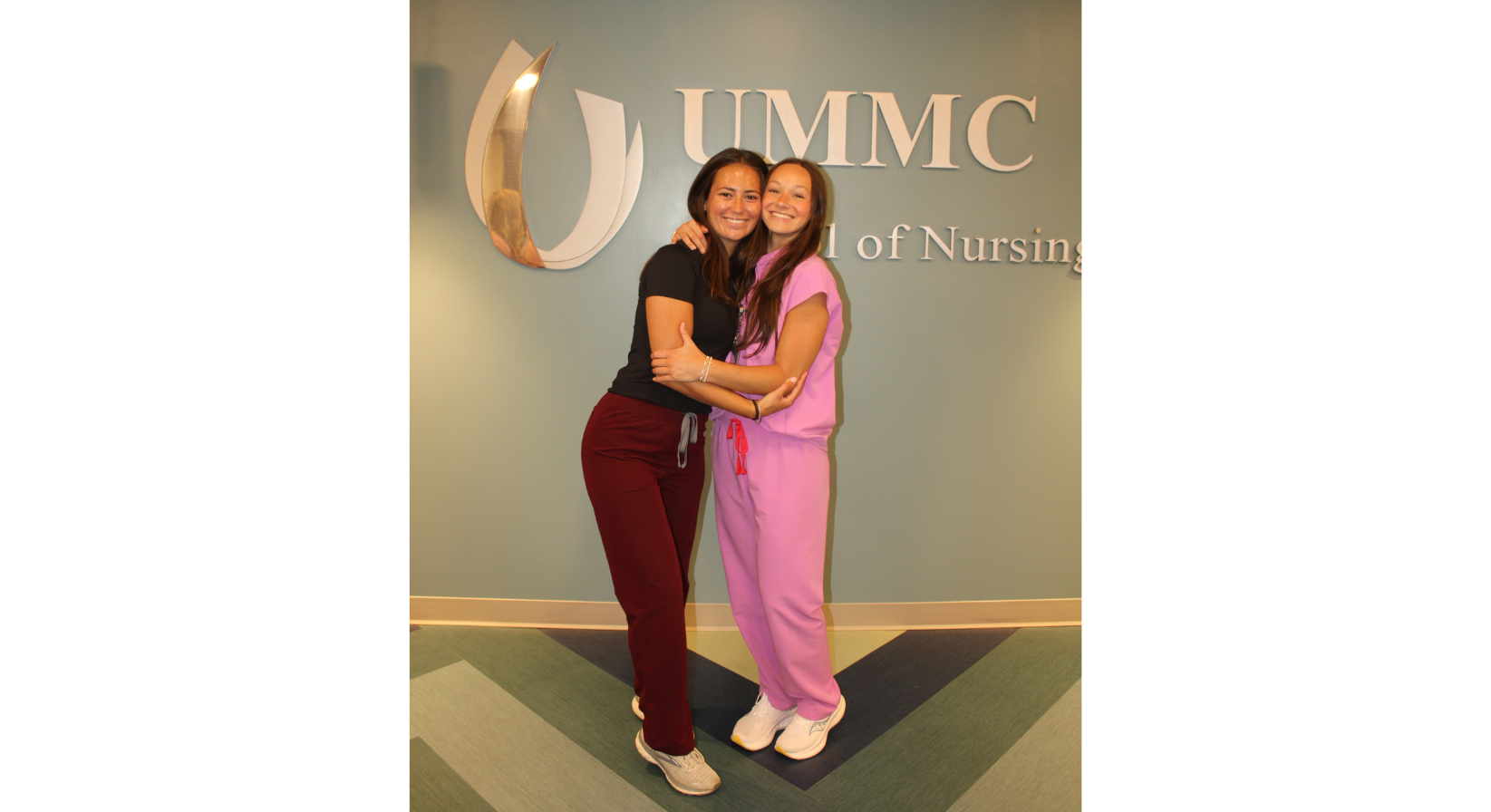 Image of Elizabeth Gann and her friend, Lauren Barbee, hugging and smiling for a picture.