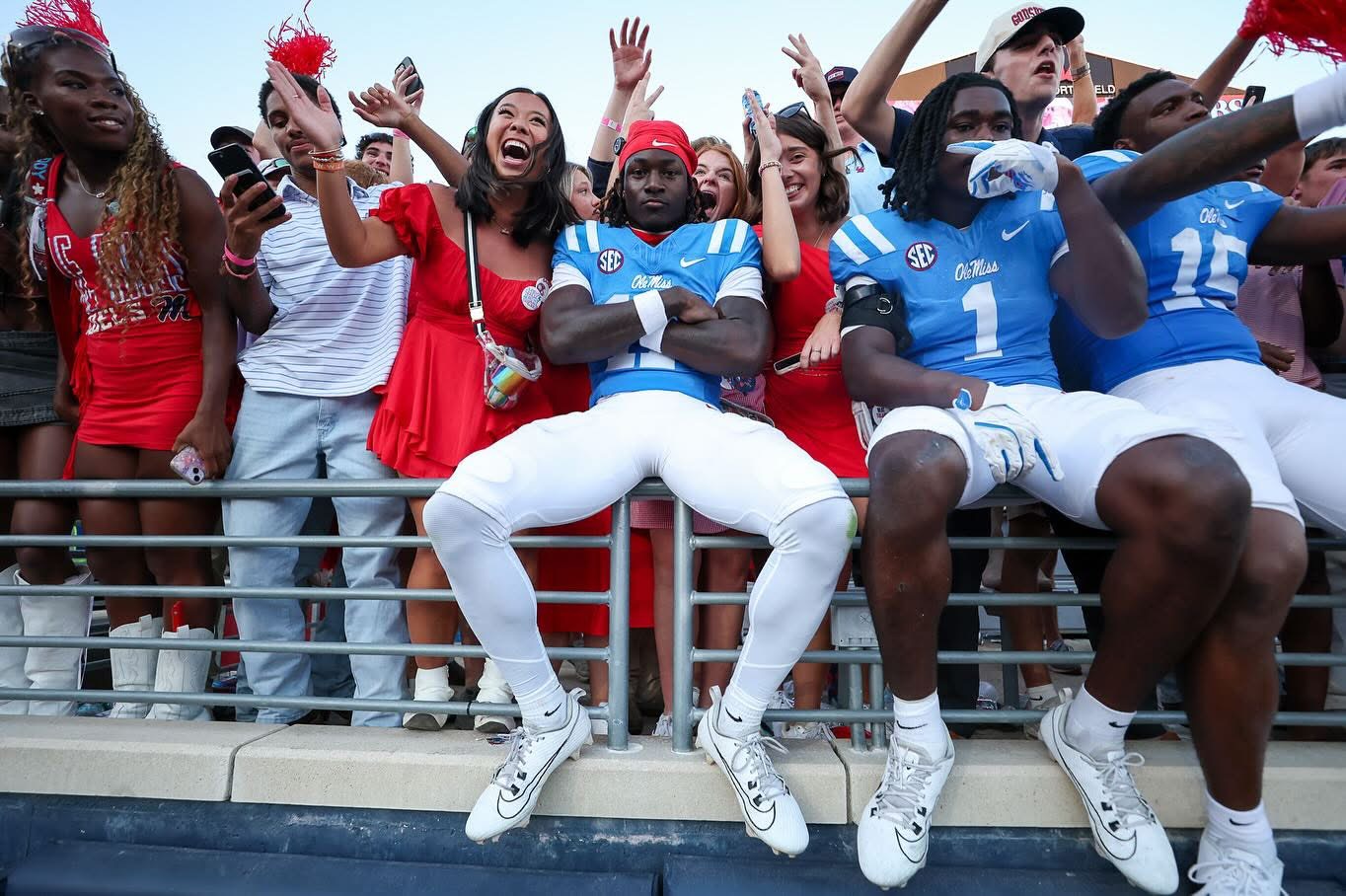 Image of students and football players celebrating a win.