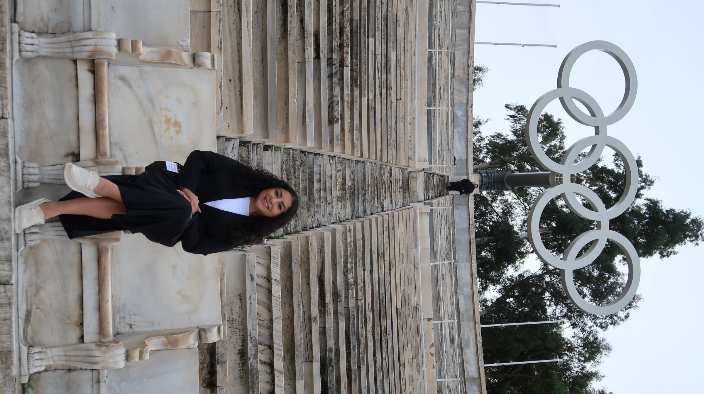 Salazar stands in front of the Olympic Rings in Greece.
