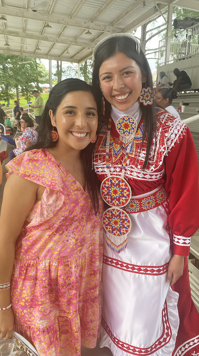 Ben wears Choctaw regalia and takes a photo with a friend.