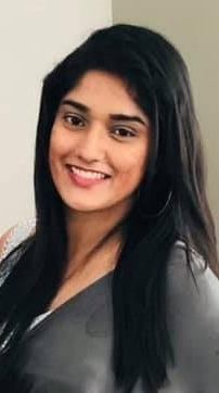 Headshot of a young woman wearing a gray blouse.