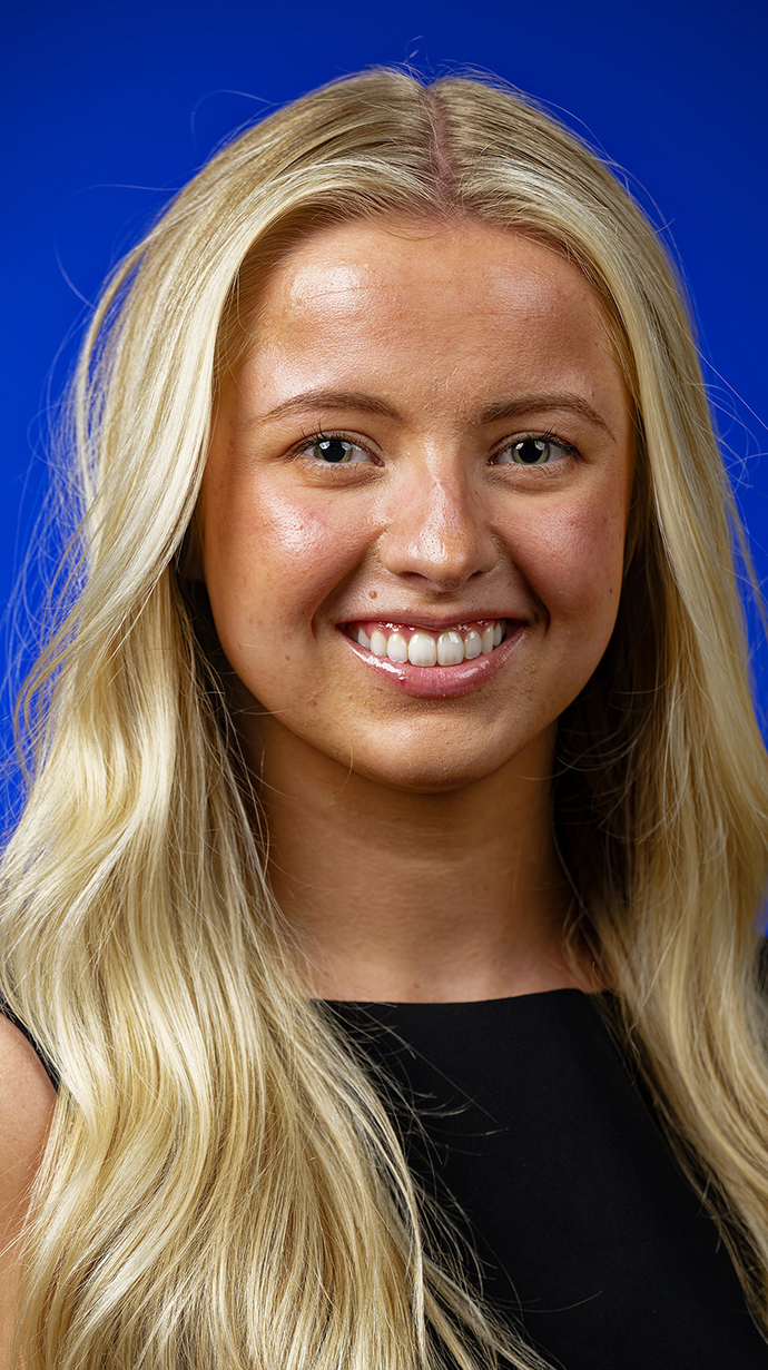 Headshot of a young woman wearing a black dress.