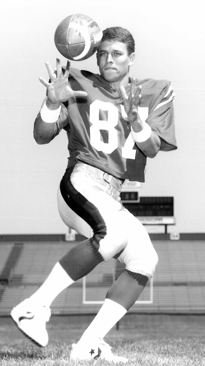 A football player catches a pass.
