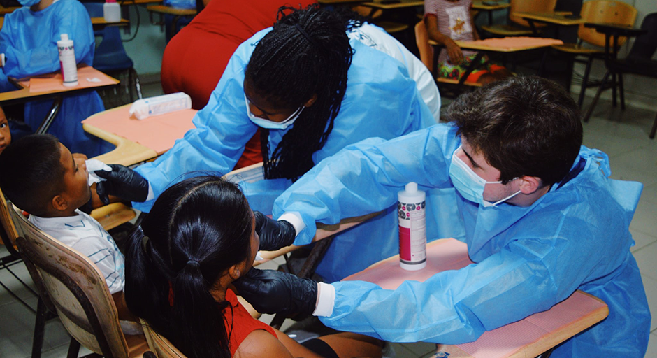 Dymond Mitchell and honors peer Jackson Sues provide medical care for children in Metetí, Panama.