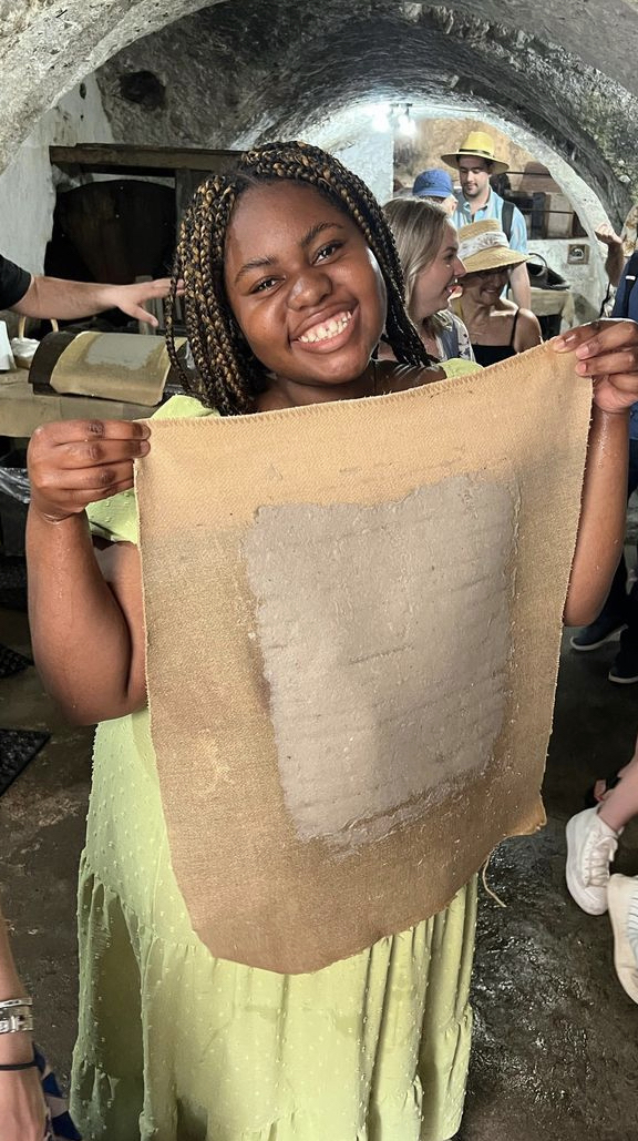 Dymond Mitchell holds ancient paper in Salerno.