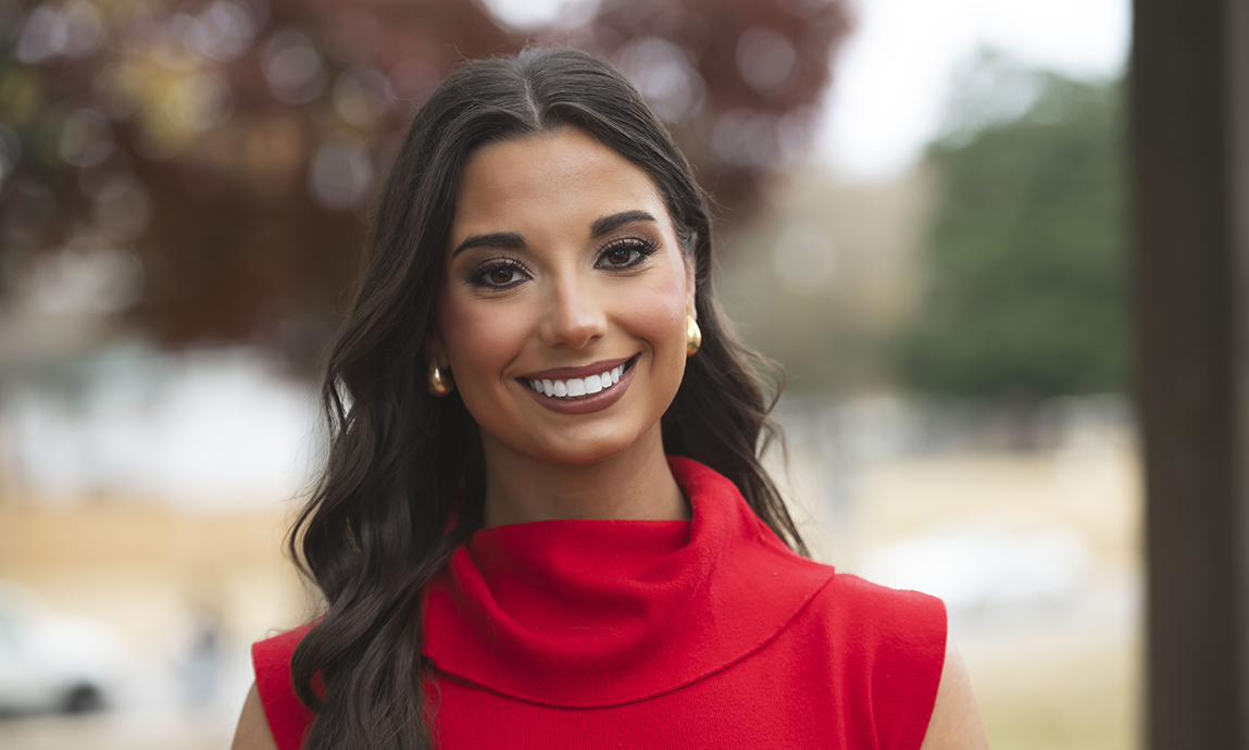 Headshot of a young woman wearing a red sleeveless sweater.
