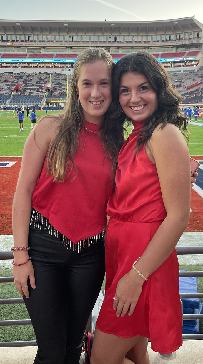 Bacon attends an Ole Miss football game with a friend.