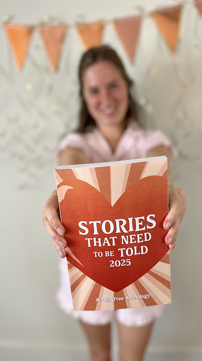 A young woman holds a book up to the camera.