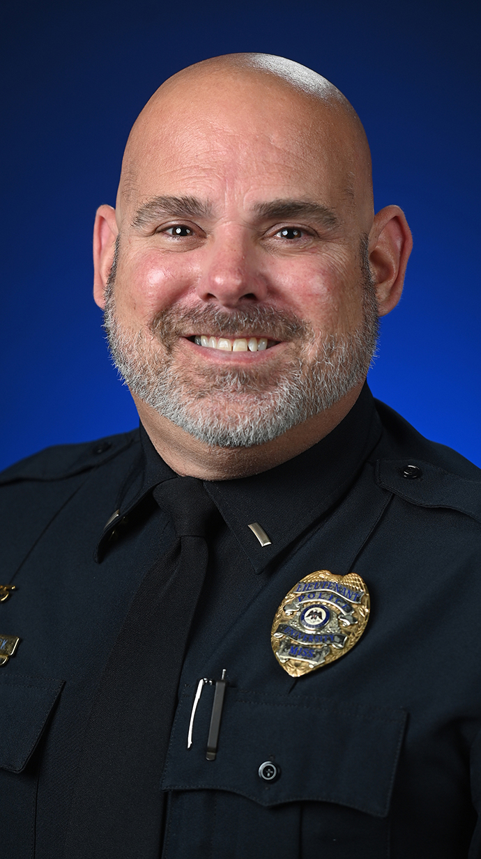 Headshot of a man wearing a police uniform.