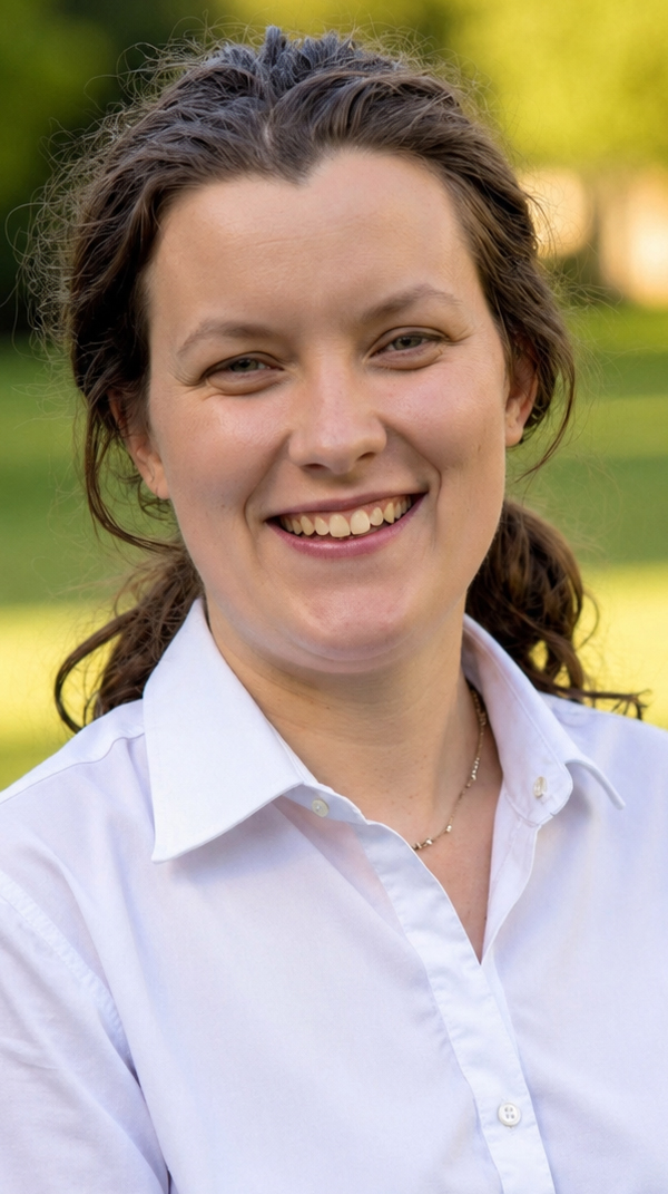 Headshot of a young woman wearing a white blouse.